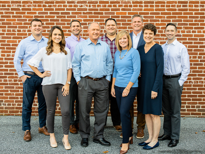Align Advisors team in front of a red brick wall